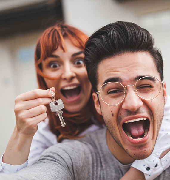 Happy couple holding keys to new house